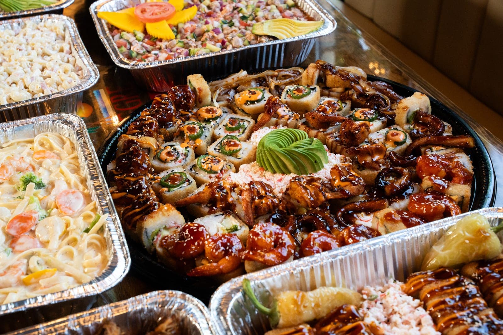 Catering tray with sushi, ceviche and seafood pasta from Mariscos Costa Alegre