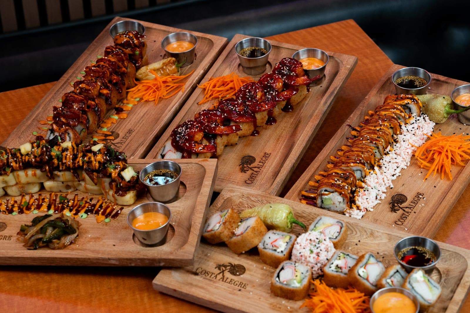 Assortment of sushi rolls served on Costa Alegre wood boards